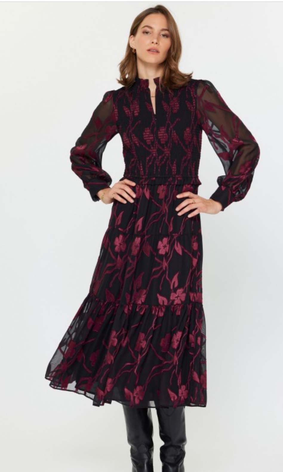 Woman wearing a floral jacquard tiered long dress on a white background