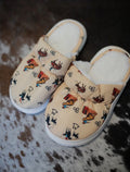 Pair of slippers with cowgirl character pattern on a textured surface