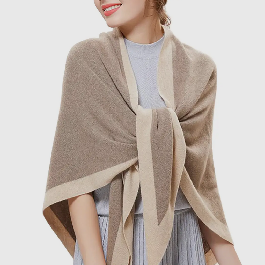 Woman wearing a beige shawl over a light gray outfit on a white background