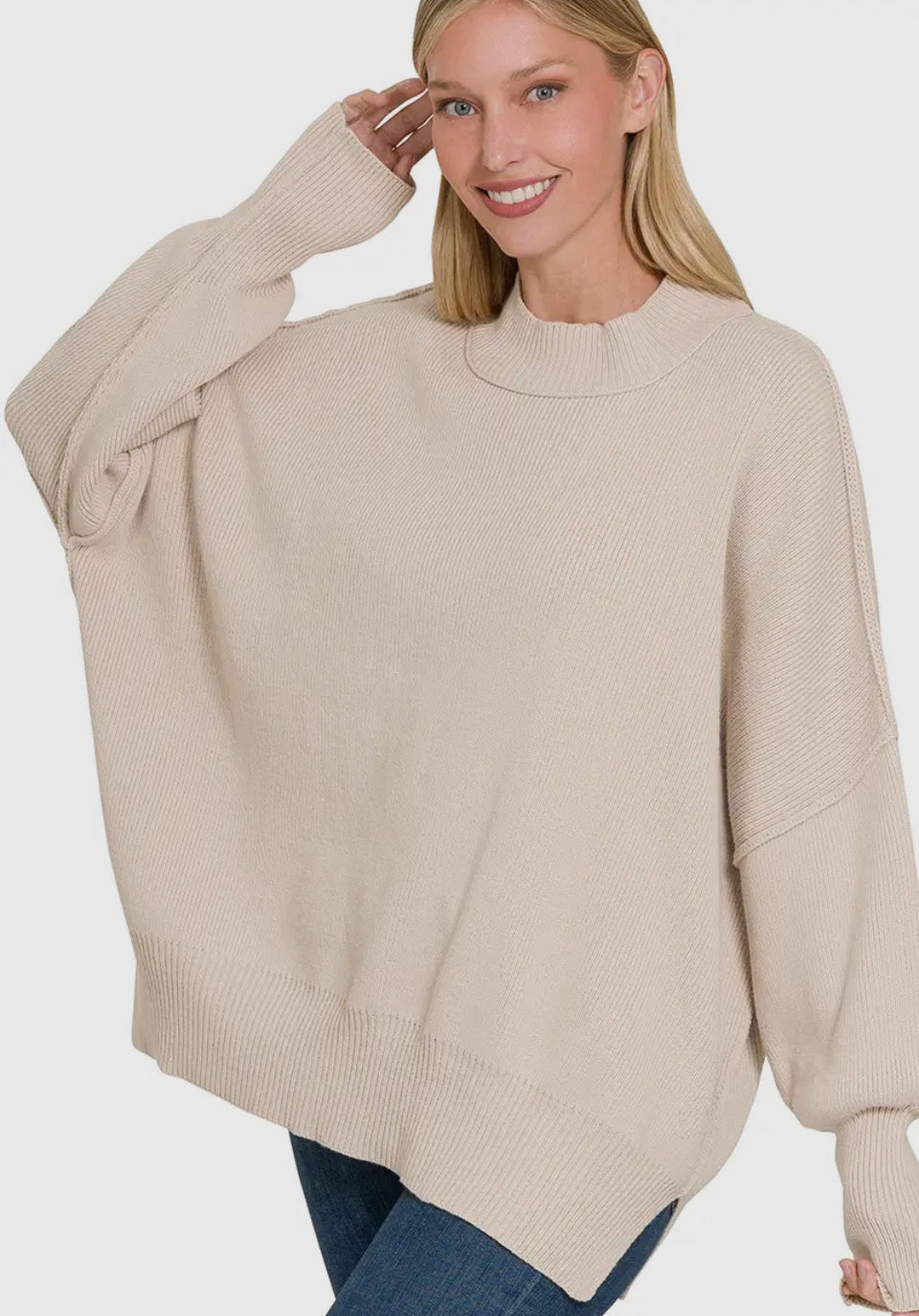 Woman wearing a sand beige sweater on a white background